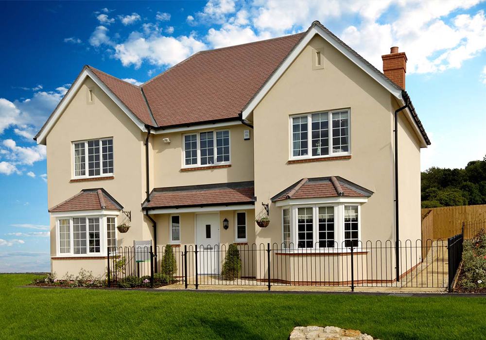 Two-story home with a clean driveway and manicured lawn