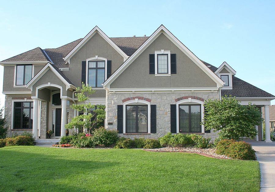 Gray two-story home with a green lawn